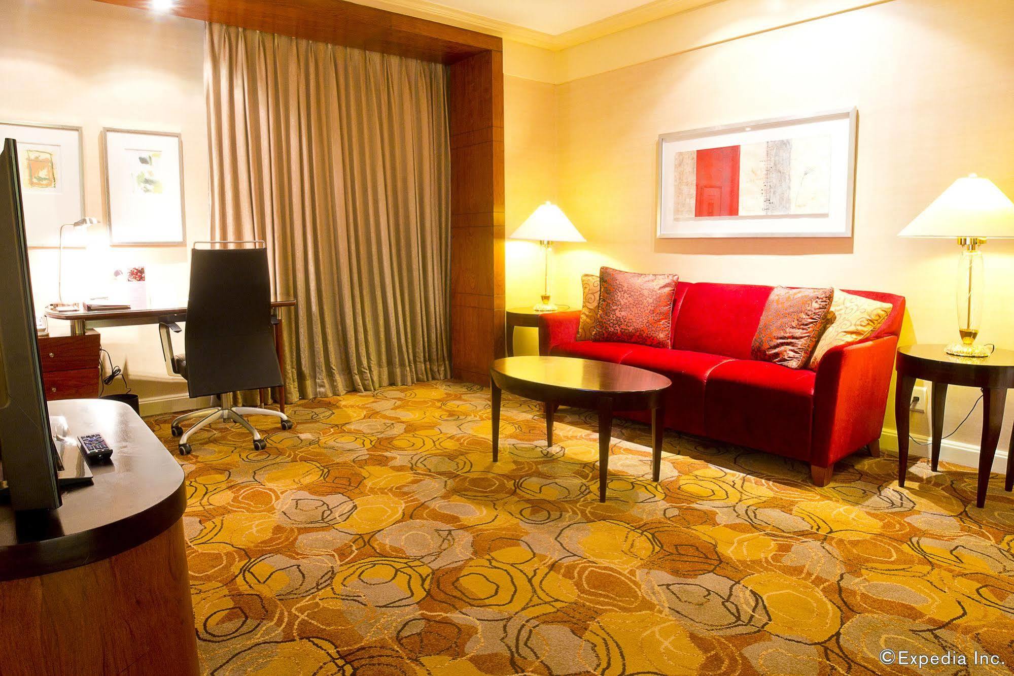New Coast Hotel Manila Exteriör bild A living room in a suite at the Shangri-La Hotel, Kuala Lumpur